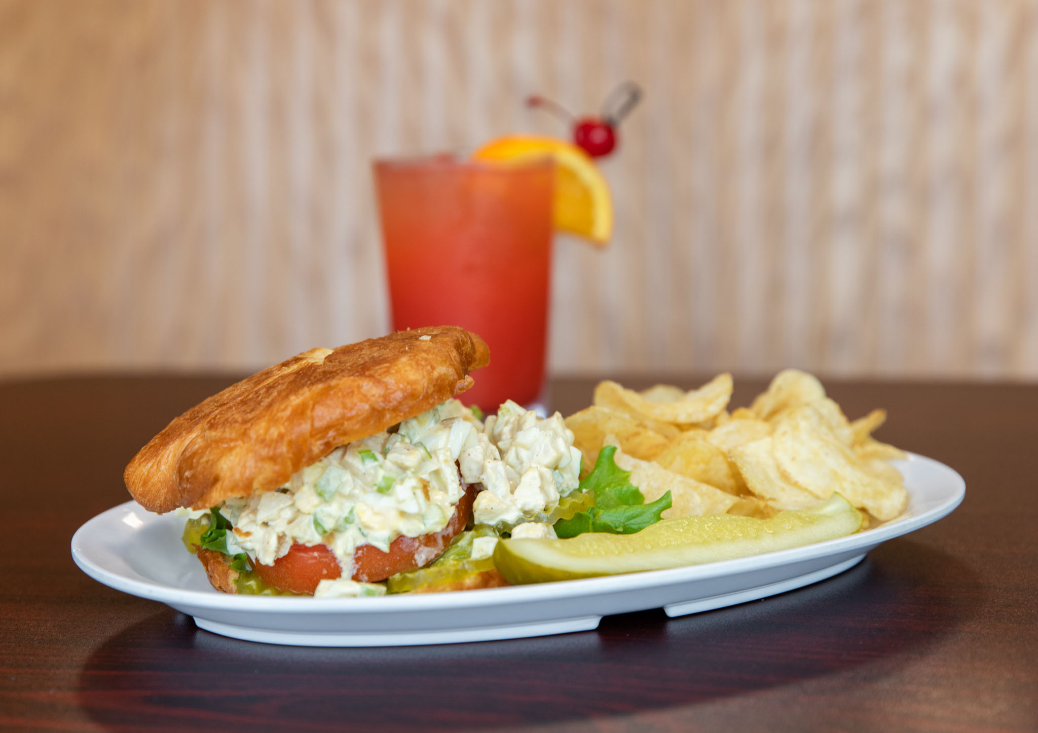 Chicken salad sandwich with lettuce and tomato on a croissant