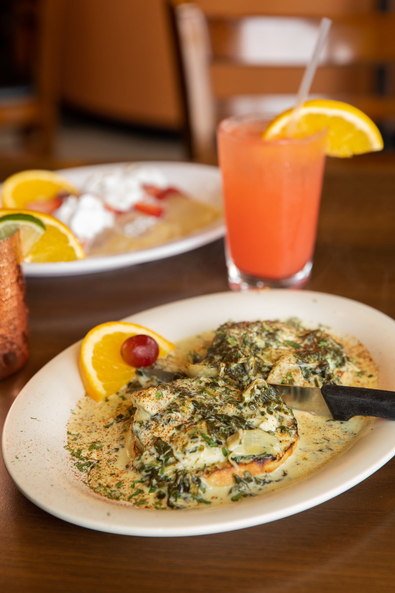 Plate of creamy spinach-topped eggs benedict