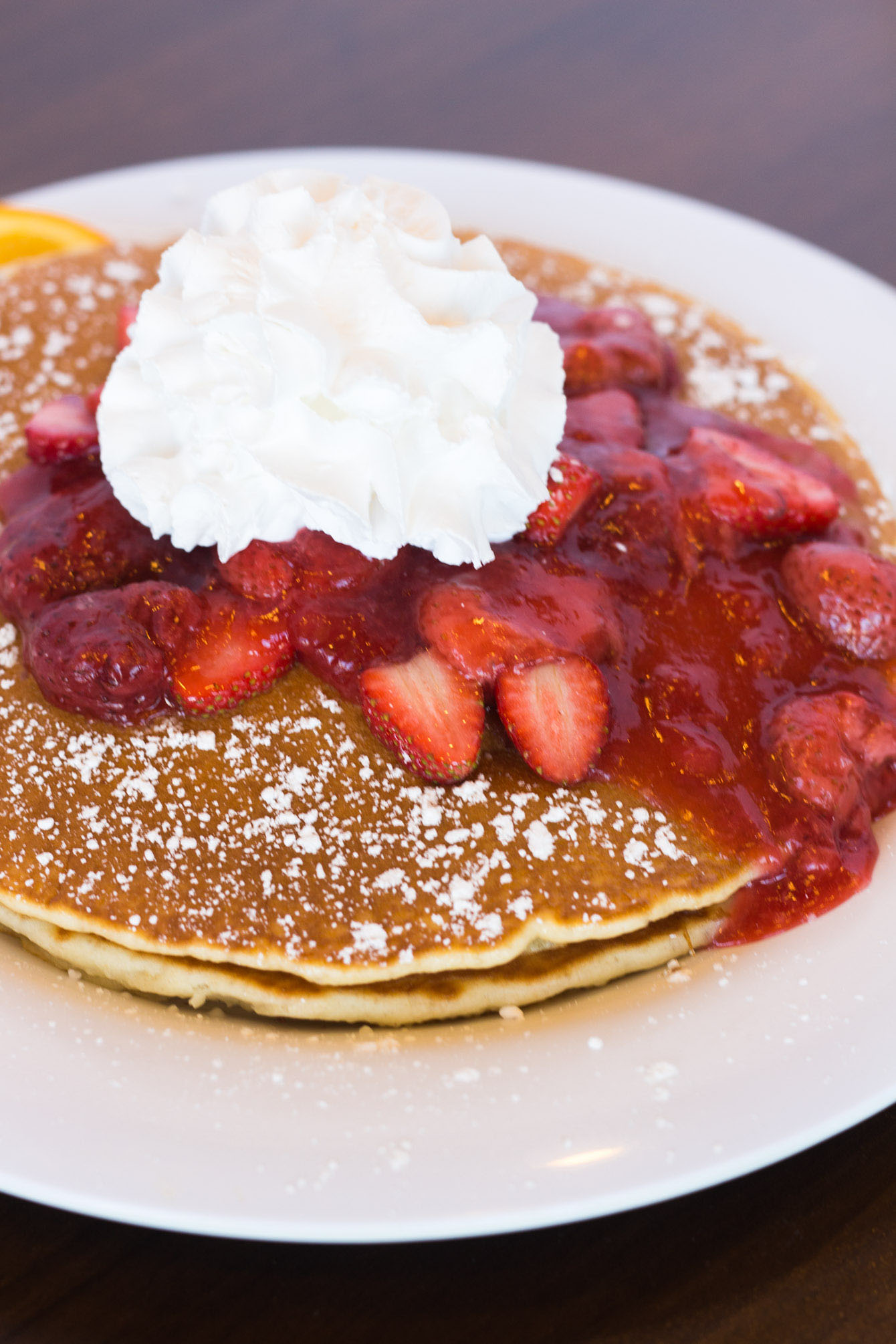 Fluffy pancakes topped with a generous portion of strawberry compote
