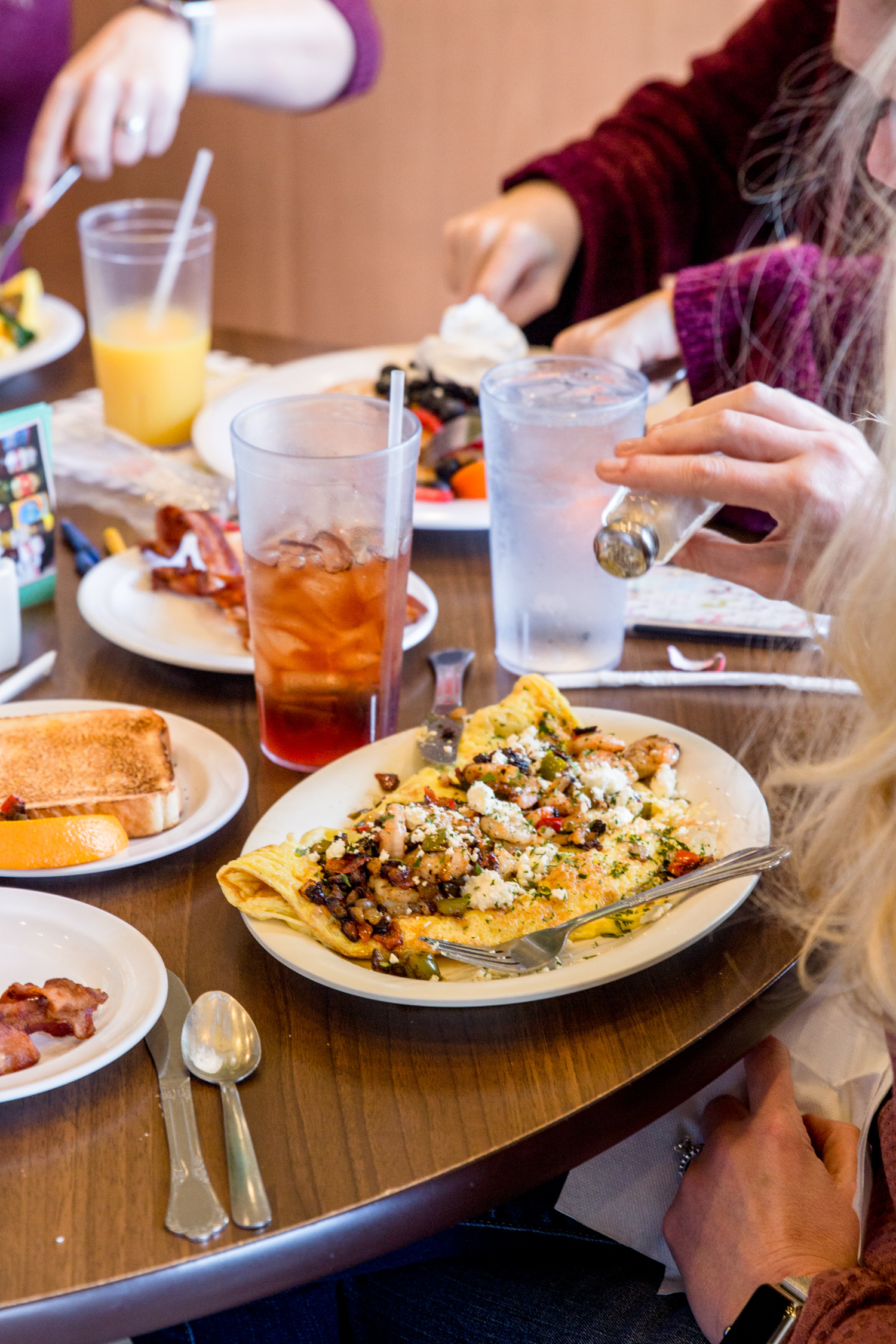 A colorful veggie omelette topped with cheese and sautéed vegetables